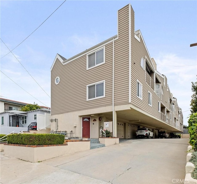 1126 W 13th St Unit 1, San Pedro, CA 90731 - view of property with a carport, concrete driveway, and an attached garage