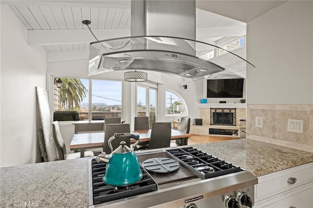 1126 W 13th St Unit 1, San Pedro, CA 90731 - kitchen with light stone countertops, beamed ceiling, a high end fireplace, decorative backsplash, and gas stovetop