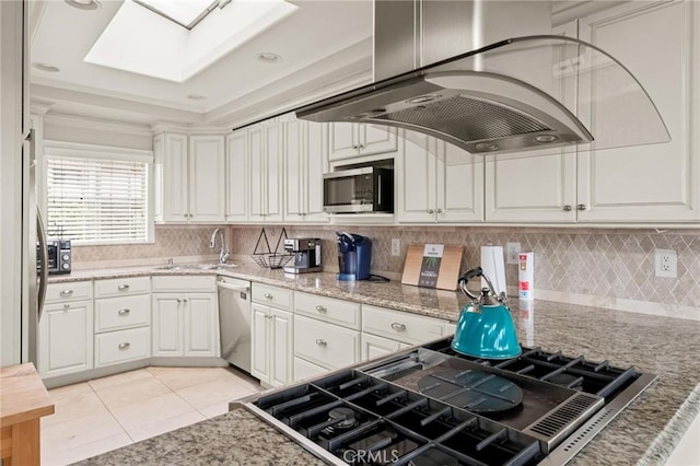 1126 W 13th St Unit 1, San Pedro, CA 90731 - kitchen featuring appliances with stainless steel finishes, island exhaust hood, a skylight, a sink, and decorative backsplash