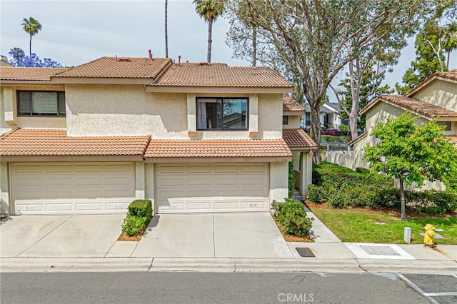 1130 Whitewater Dr Unit 263, Fullerton, CA 92833 - view of front of home with concrete driveway, a tile roof, stucco siding, and an attached garage