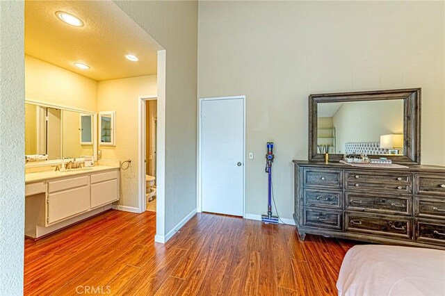 1130 Whitewater Dr Unit 263, Fullerton, CA 92833 - bedroom featuring wood finished floors, a sink, baseboards, and ensuite bathroom