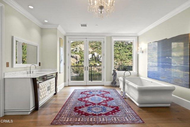 2112 Trentham Rd, Triunfo Pass-Point Mugu, CA 91361 - full bath featuring french doors, vanity, a freestanding tub, ornamental molding, and a chandelier
