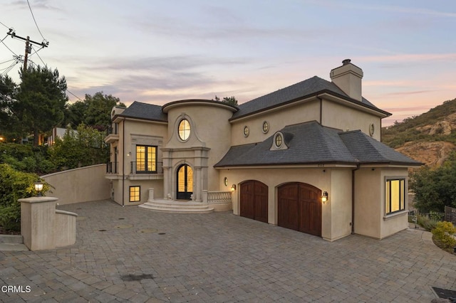 2112 Trentham Rd, Triunfo Pass-Point Mugu, CA 91361 - french provincial home with a garage, stucco siding, a chimney, and driveway