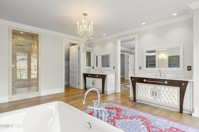 2112 Trentham Rd, Triunfo Pass-Point Mugu, CA 91361 - bathroom with a soaking tub, wood finished floors, vanity, ornamental molding, and recessed lighting