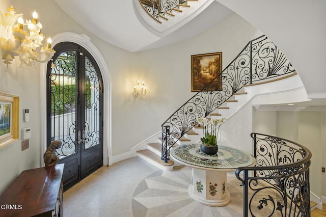2112 Trentham Rd, Triunfo Pass-Point Mugu, CA 91361 - foyer entrance featuring arched walkways, a chandelier, french doors, and stairway