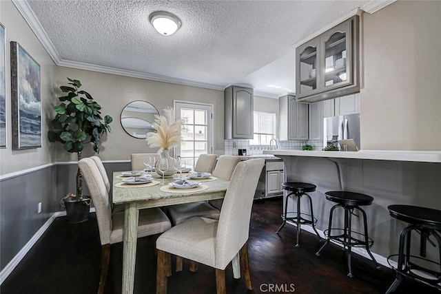 312 N Prospect Ave, Redondo Beach, CA 90277 - dining space with dark wood-style flooring, a textured ceiling, and crown molding