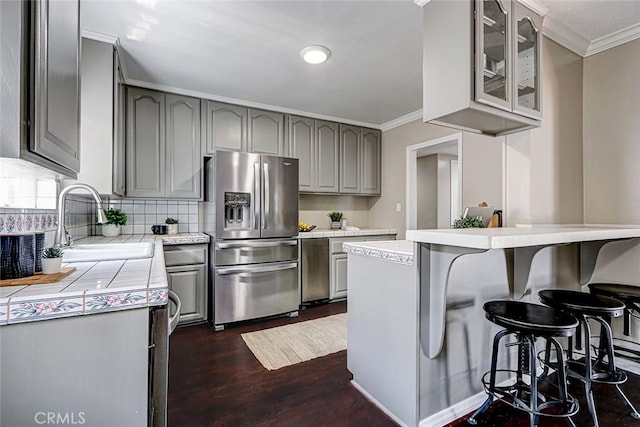 312 N Prospect Ave, Redondo Beach, CA 90277 - kitchen featuring stainless steel fridge with ice dispenser, gray cabinets, crown molding, glass insert cabinets, and dark wood finished floors
