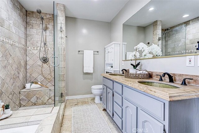 312 N Prospect Ave, Redondo Beach, CA 90277 - bathroom with double vanity, a stall shower, toilet, baseboards, and tile patterned floors