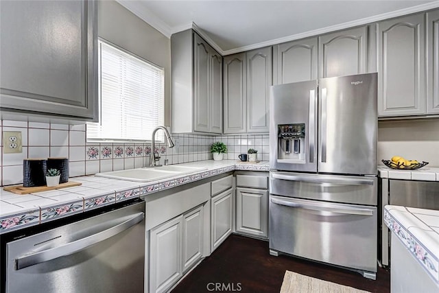 312 N Prospect Ave, Redondo Beach, CA 90277 - kitchen featuring appliances with stainless steel finishes, gray cabinets, tile countertops, a sink, and backsplash