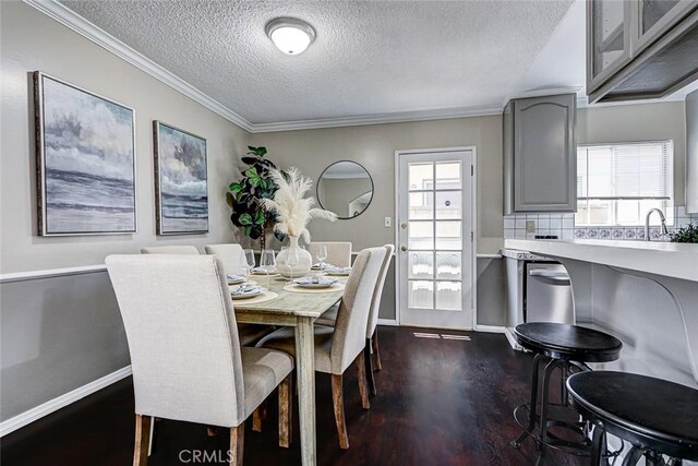 312 N Prospect Ave, Redondo Beach, CA 90277 - dining space featuring a textured ceiling, dark wood-type flooring, ornamental molding, and baseboards