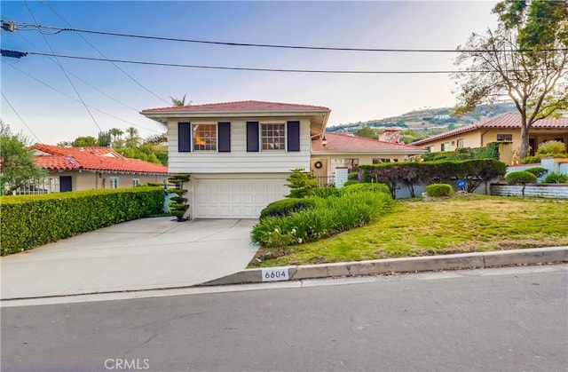 6604 Via Siena, Rancho Palos Verdes, CA 90275 - tri-level home featuring a garage, concrete driveway, and a front lawn