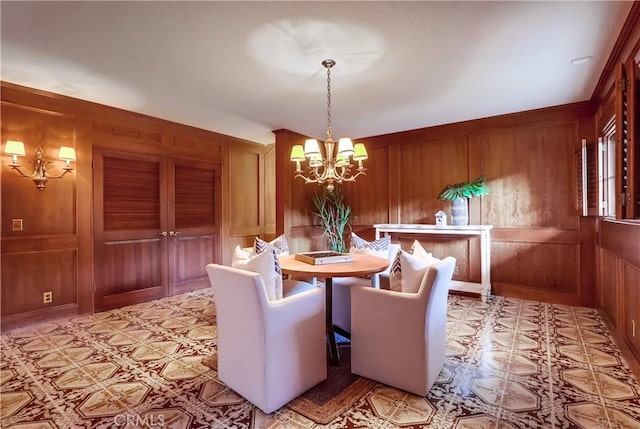 6604 Via Siena, Rancho Palos Verdes, CA 90275 - dining area with wooden walls, a chandelier, and light floors