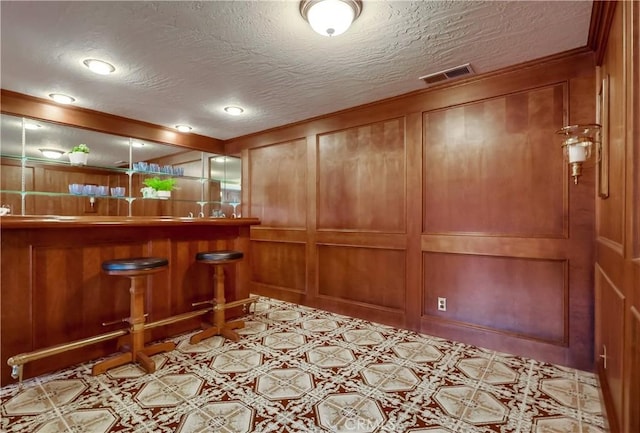 6604 Via Siena, Rancho Palos Verdes, CA 90275 - indoor dry bar featuring a textured ceiling, recessed lighting, a decorative wall, wooden walls, and tile patterned floors