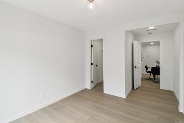 3243 Carolyn Cir, Oceanside, CA 92054 - unfurnished bedroom with light wood finished floors, baseboards, and a walk in closet
