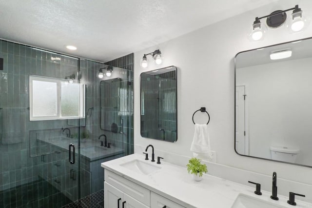 3243 Carolyn Cir, Oceanside, CA 92054 - bathroom featuring double vanity, a shower stall, toilet, and a textured ceiling