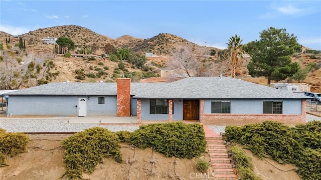31346 Indian Oaks Rd, Acton, CA 93510 - ranch-style home with a mountain view, a chimney, stairs, a shingled roof, and brick siding