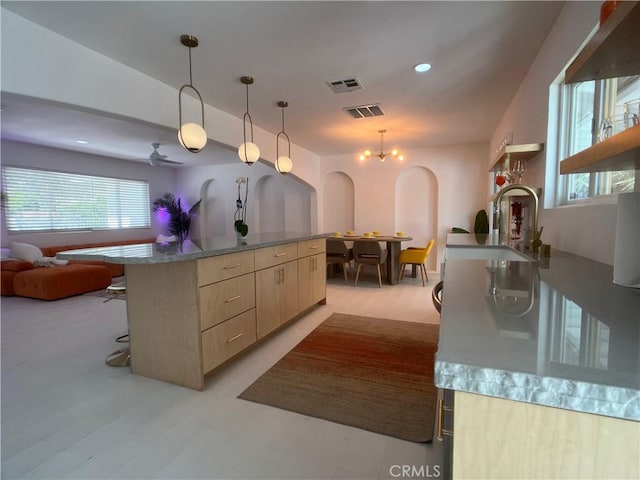 622 S Highland Dr, Palm Springs, CA 92264 - kitchen with light brown cabinets, healthy amount of natural light, open floor plan, arched walkways, and recessed lighting