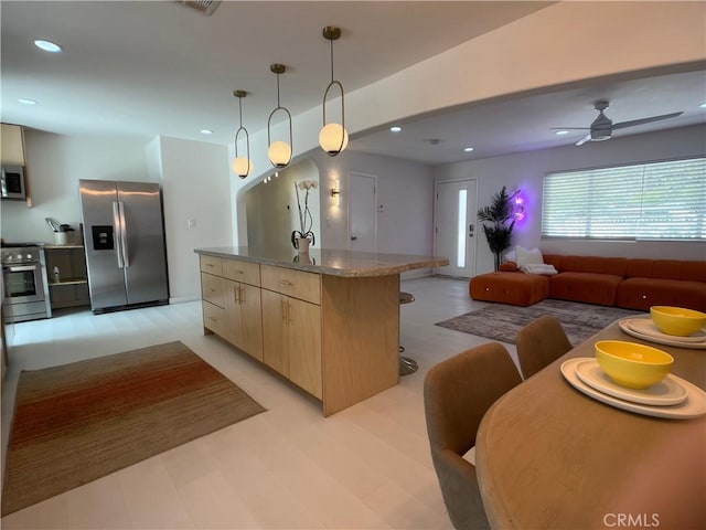 622 S Highland Dr, Palm Springs, CA 92264 - kitchen featuring stainless steel appliances, open floor plan, light brown cabinetry, modern cabinets, and a center island with sink