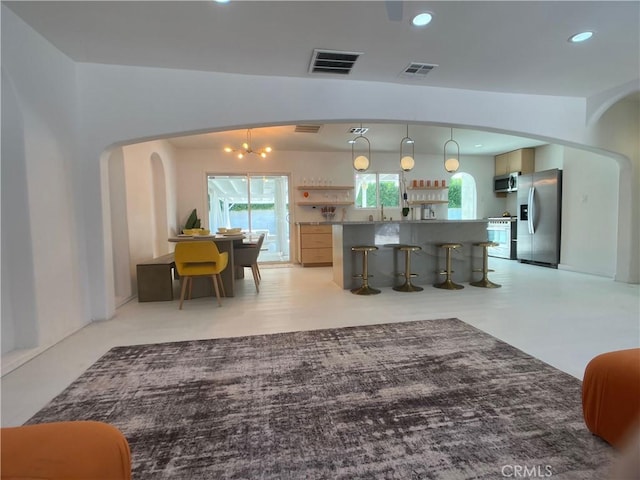 622 S Highland Dr, Palm Springs, CA 92264 - kitchen with stainless steel appliances, arched walkways, recessed lighting, a kitchen breakfast bar, and a sink