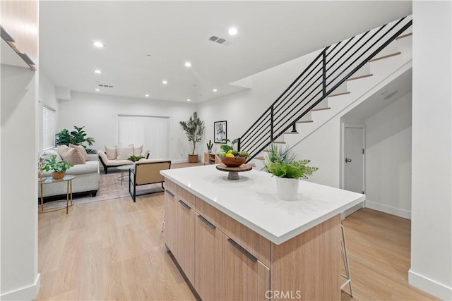 436 E Truslow Ave, Fullerton, CA 92832 - kitchen with a center island, modern cabinets, light wood-style floors, a breakfast bar, and light countertops