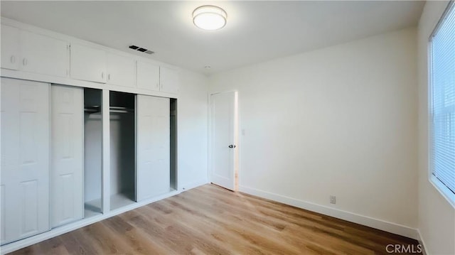 436 E Truslow Ave, Fullerton, CA 92832 - unfurnished bedroom with a closet, light wood-type flooring, baseboards, and multiple windows