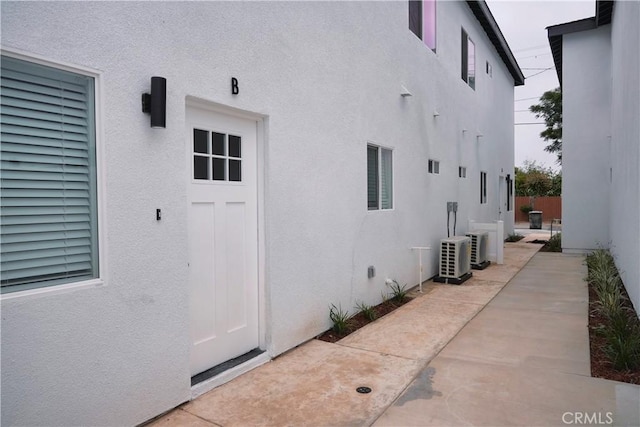 436 E Truslow Ave, Fullerton, CA 92832 - entrance to property featuring stucco siding, a patio area, and a cooling unit