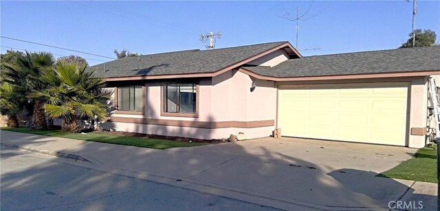 206 S Oak Glen Ave, Nipomo, CA 93444 - view of front of home featuring concrete driveway, a garage, stucco siding, and roof with shingles