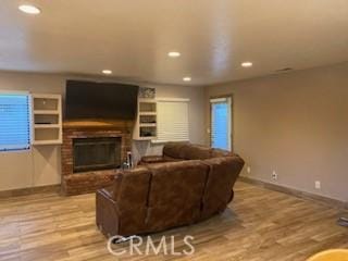 206 S Oak Glen Ave, Nipomo, CA 93444 - living area featuring a fireplace, recessed lighting, wood finished floors, and baseboards