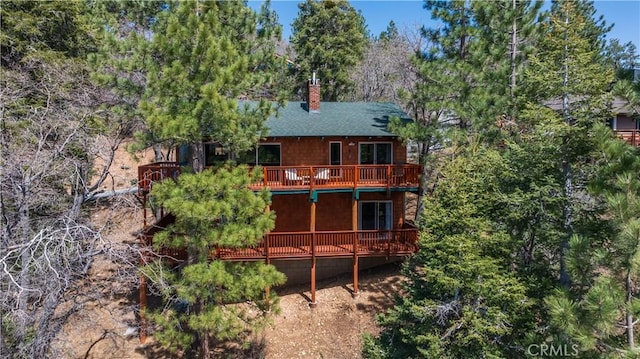 43897 Yosemite Dr, Big Bear Lake, CA 92315 - rear view of house featuring a chimney, a wooden deck, and roof with shingles