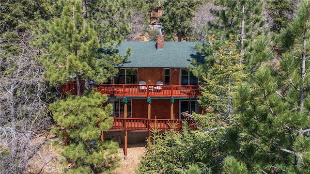 43897 Yosemite Dr, Big Bear Lake, CA 92315 - rear view of property with a deck, a shingled roof, and a chimney