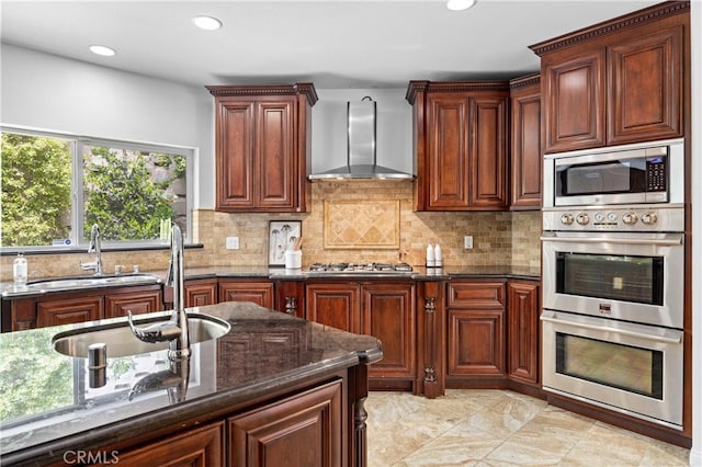 2421 N Feather Hill Dr, Orange, CA 92867 - kitchen featuring wall chimney range hood, a sink, appliances with stainless steel finishes, dark stone countertops, and decorative backsplash