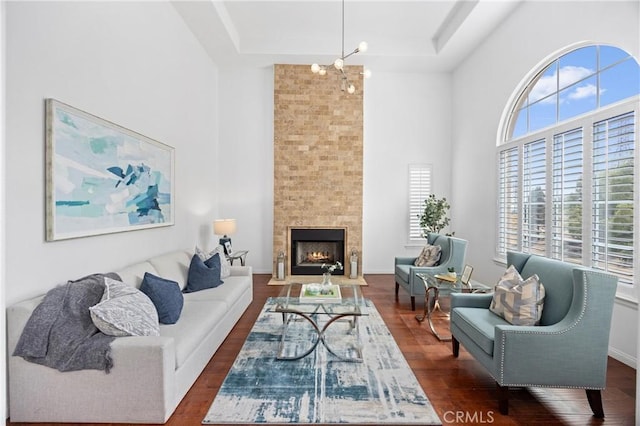 2421 N Feather Hill Dr, Orange, CA 92867 - living area with healthy amount of natural light, a towering ceiling, dark wood-style floors, a tray ceiling, and a fireplace