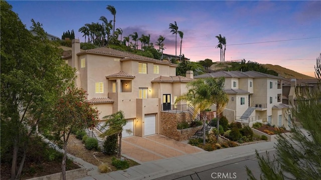 2421 N Feather Hill Dr, Orange, CA 92867 - mediterranean / spanish-style home with a chimney, concrete driveway, a tile roof, and stucco siding