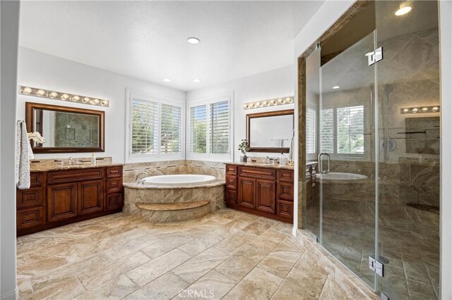 2421 N Feather Hill Dr, Orange, CA 92867 - full bath featuring healthy amount of natural light, a bath, two vanities, a shower stall, and recessed lighting