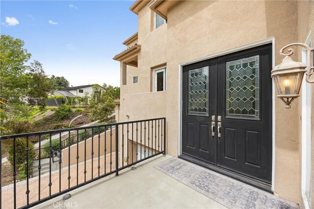 2421 N Feather Hill Dr, Orange, CA 92867 - entrance to property with stucco siding, french doors, and a balcony