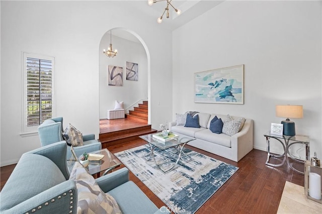 2421 N Feather Hill Dr, Orange, CA 92867 - living room featuring a chandelier, arched walkways, wood finished floors, stairs, and a high ceiling
