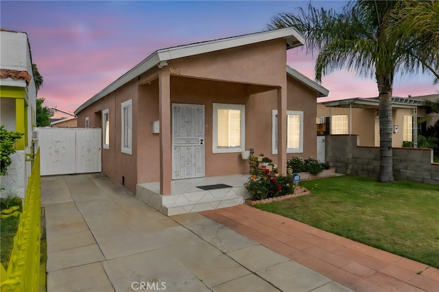 9637 San Carlos Ave, South Gate, CA 90280 - view of front facade featuring stucco siding and a front lawn