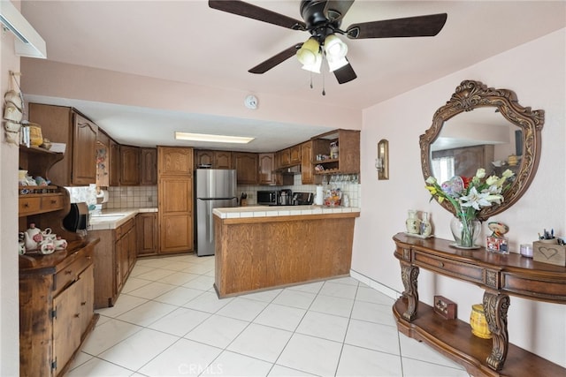 9637 San Carlos Ave, South Gate, CA 90280 - kitchen with freestanding refrigerator, open shelves, a peninsula, tasteful backsplash, and tile counters