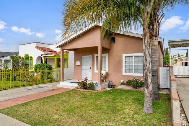 9637 San Carlos Ave, South Gate, CA 90280 - view of front facade with stucco siding, driveway, and a gate