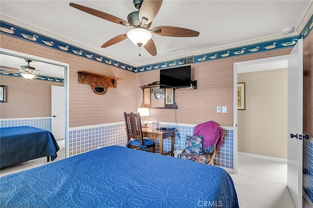 17 Toledo Dr, Rancho Mirage, CA 92270 - bedroom featuring wallpapered walls, wainscoting, crown molding, a ceiling fan, and carpet flooring