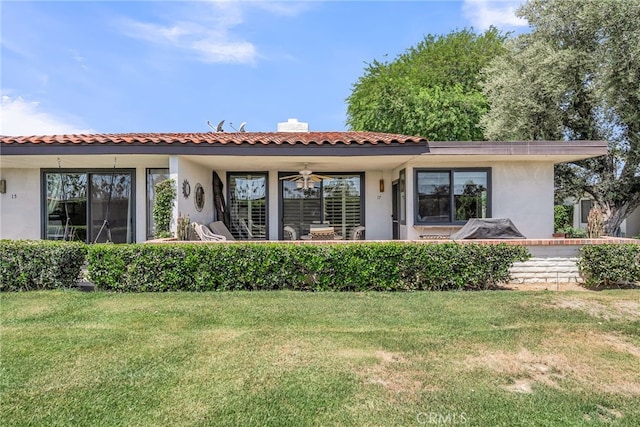 17 Toledo Dr, Rancho Mirage, CA 92270 - back of house with stucco siding, a lawn, and a ceiling fan