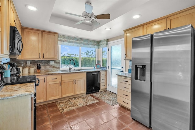 17 Toledo Dr, Rancho Mirage, CA 92270 - kitchen featuring black appliances, a sink, light brown cabinetry, a raised ceiling, and light stone countertops