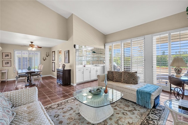 17 Toledo Dr, Rancho Mirage, CA 92270 - living area with dark tile patterned flooring, baseboards, ceiling fan, and vaulted ceiling