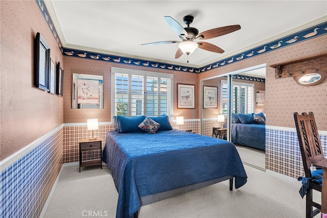 17 Toledo Dr, Rancho Mirage, CA 92270 - carpeted bedroom featuring wallpapered walls, wainscoting, multiple windows, and ceiling fan