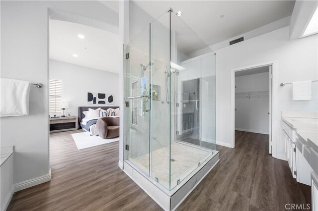 2517 Tequestra, Tustin, CA 92782 - full bathroom featuring a shower stall, wood finished floors, vanity, baseboards, and a walk in closet