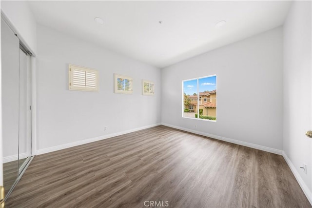 2517 Tequestra, Tustin, CA 92782 - unfurnished bedroom with wood finished floors, baseboards, a closet, and recessed lighting