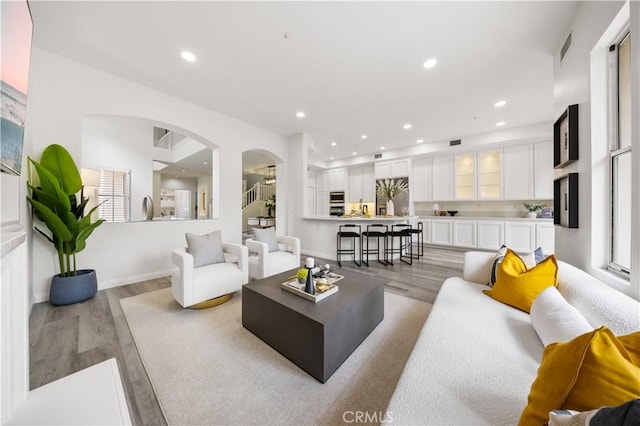 2517 Tequestra, Tustin, CA 92782 - living room with light wood-style floors, arched walkways, recessed lighting, and baseboards