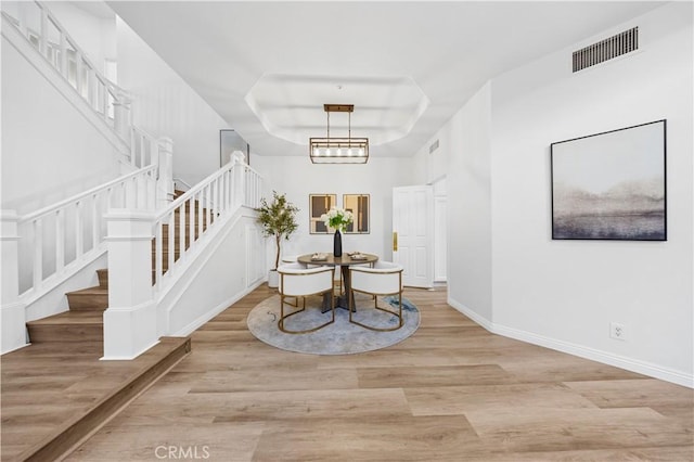 2517 Tequestra, Tustin, CA 92782 - dining space with stairs, wood finished floors, a tray ceiling, and baseboards