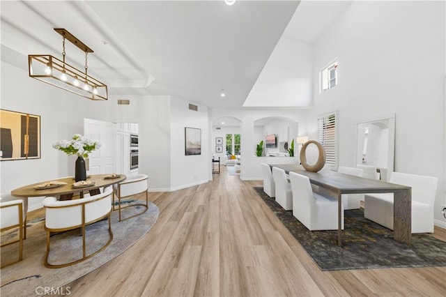 2517 Tequestra, Tustin, CA 92782 - dining area with high vaulted ceiling, light wood-style floors, healthy amount of natural light, baseboards, and recessed lighting