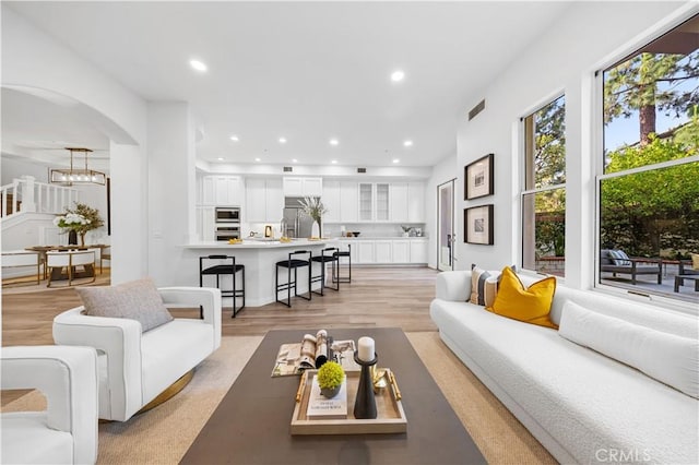 2517 Tequestra, Tustin, CA 92782 - living area featuring light wood finished floors, arched walkways, and recessed lighting